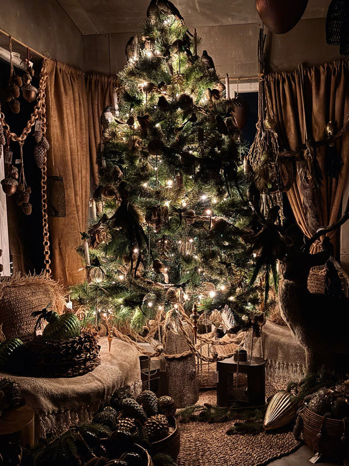 Decorated Christmas tree in a cozy room with warm lighting